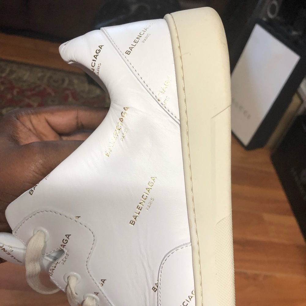 Balenciaga White low ride sneaker with gold.